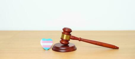 Transgender Day, LGBTQ Law and Pride month concepts. gavel justice hammer with blue, pink and white heart shape for Lesbian, Gay, Bisexual, Queer, Intersex photo