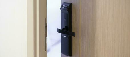 smart digital door lock while open or close the door at home or apartment. NFC Technology, Fingerprint scan, keycard, PIN number, smartphone, electrical and contactless lifestyle concepts photo