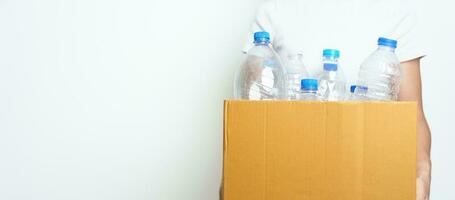 Volunteer keep plastic bottle into paper box at home or office. Hand Sorting Recycle garbage. Ecology, Environmental, pollution, Dispose recycling, waste management and trash Separation concept photo