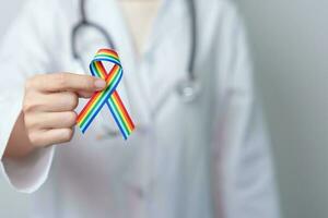 Doctor with LGBTQ Rainbow ribbon for Support Lesbian, Gay, Bisexual, Transgender and Queer community and happy Pride month concept photo