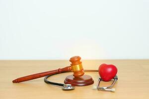 Gavel and stethoscope on table. Medical and Health Law, legal of medical malpractice concept photo