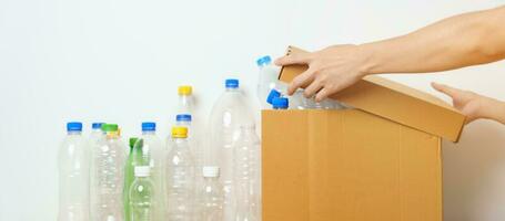 Volunteer keep plastic bottle into paper box at home or office. Hand Sorting Recycle garbage. Ecology, Environmental, pollution, Dispose recycling, waste management and trash Separation concept photo