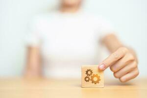 hand hold gear block with business goal, strategy, teamwork, target, mission, action, objective, brainstorming  and success concept photo