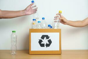 Volunteer keep plastic bottle into paper box at home or office. Hand Sorting Recycle garbage. Ecology, Environmental, pollution, Dispose recycling, waste management and trash Separation concept photo