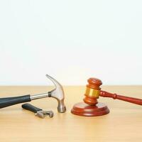 Labor law and Worker concepts. Construction hammer with gavel justice hammer on desk in courthouse. photo