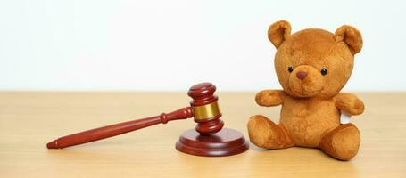 Children, Kid and Family Law concepts. toy bear with gavel justice hammer on desk in courthouse. photo