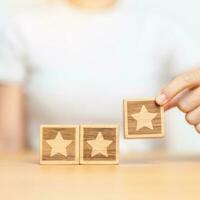 hand holding Star block. Customer choose rating for user reviews. Quality, Service rating, ranking, customer review, satisfaction, evaluation and feedback concept photo