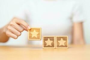 hand holding Star block. Customer choose rating for user reviews. Quality, Service rating, ranking, customer review, satisfaction, evaluation and feedback concept photo