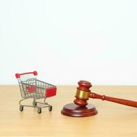 Judge gavel and small shopping cart on desk. online auction and bidding, Trade Regulations, Consumer protection Law, online shopping, E commerce, Tax, Digital, justice and judgment concept photo