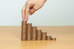 Money Saving for Future Plan, Retirement fund, Pension, Investment, Wealth, Salary and Financial concepts. hand step up coin on table, Money Counting and stack arrangement for Growth photo