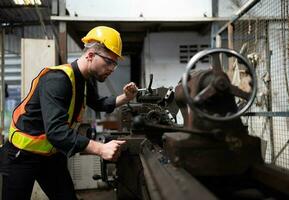 Mechanical engineers enter the old machinery warehouse to inspect and repair used machinery with the warehouse's personnel. photo