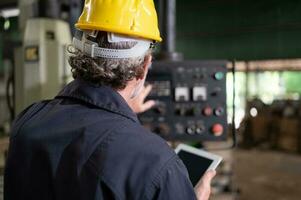 Senior technicians inspect and repair mechanical systems in machine control cabinets. in order for the machine to return to normal operation photo