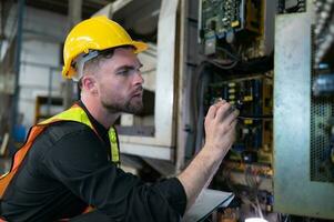 The engineer inspects the electrical system and repairs the mechanical system in the machine control cabinet. in order for the machine to return to normal operation photo