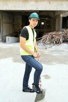 South East Asian young Malay Chinese man woman wearing safely helmet construction site work photo