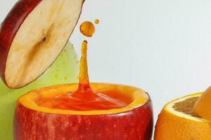 Red Apple real juice splash in fresh half cut hollow cup fruit photo