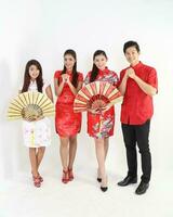 South East Asian young Malay Chinese Indian man woman wearing traditional chinse cheongsam dress on white background shop exchange gift orange greetings share racial unity harmony hand fan photo