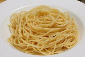 Cooked plain spaghetti on white plate photo