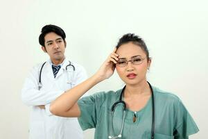 young asian malay chinese male female doctor on white background headache angry annoyed hand on head look at camera photo