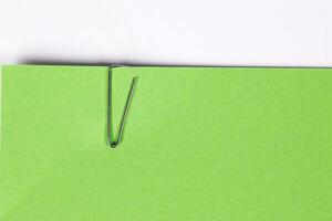 Paper clip holding on blank colour paper text copy space note photo