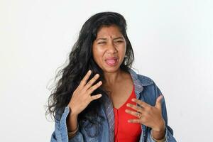 Young attractive Asian Indian woman pose face body expression mode emotion on white background pain disgust tooth ace photo