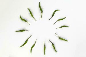 Fresh birds eye green chilli circle on white background photo