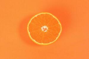 Mandarin Orange Fruit slice half on orange background photo