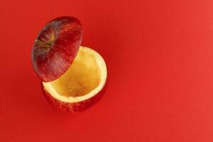 Healthy Red Cut Apple floating top slice juice drink idea concept on red background photo