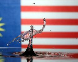 Water droplet drop splash collision dripping pillar Malaysia Flag reflection refraction independence country patriot photo