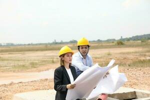 South east Asian construction worker engineer management at construction site hard safety hat helmet photo