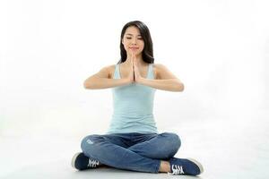 Beautiful young south east Asian Chinese woman yoga workout exercise on white background photo