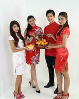 South East Asian young Malay Chinese Indian man woman wearing traditional chinse cheongsam dress on white background shop exchange gift orange greetings share racial unity harmony hand fan photo