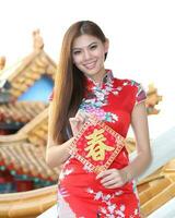 Young south east asian Chinese man woman traditional costume Chinese new year greeting outdoors at temple photo