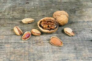 Mixed nut on rustic wood background photo