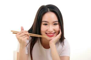Beautiful young south east Asian woman holding chinese empty chopstick soup spoon bowl utensil pretend acting posing see eat taste feed offer satisfaction yummy white background happy photo