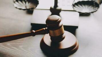 Justice and law concept.Male judge in a courtroom with the gavel, working with, computer and docking keyboard, eyeglasses, on table in morning light video