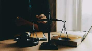 Justice and law concept.Male judge in a courtroom with the gavel, working with, computer and docking keyboard, eyeglasses, on table in morning light video