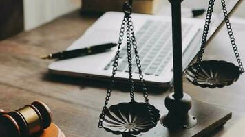 Justice and law concept.Male judge in a courtroom with the gavel, working with, computer and docking keyboard, eyeglasses, on table in morning light video