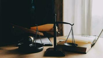 Justice and law concept.Male judge in a courtroom with the gavel, working with, computer and docking keyboard, eyeglasses, on table in morning light video