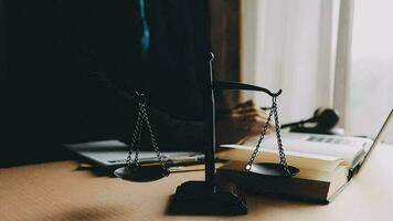 Justice and law concept.Male judge in a courtroom with the gavel, working with, computer and docking keyboard, eyeglasses, on table in morning light video