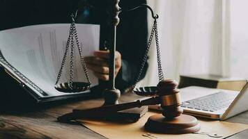 Justice and law concept.Male judge in a courtroom with the gavel, working with, computer and docking keyboard, eyeglasses, on table in morning light video