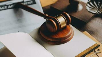 Justice and law concept.Male judge in a courtroom with the gavel, working with, computer and docking keyboard, eyeglasses, on table in morning light video