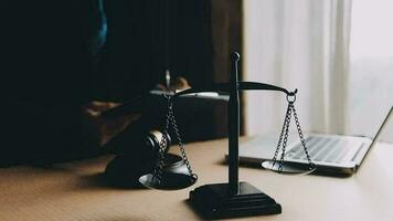 Justice and law concept.Male judge in a courtroom with the gavel, working with, computer and docking keyboard, eyeglasses, on table in morning light video