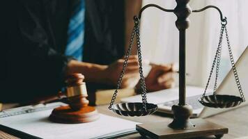Justice and law concept.Male judge in a courtroom with the gavel, working with, computer and docking keyboard, eyeglasses, on table in morning light video