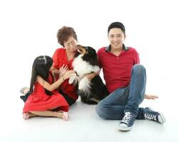 Southeast Asian multigeneration family parents daughter grandmother father mother child pose happy sit stand photo