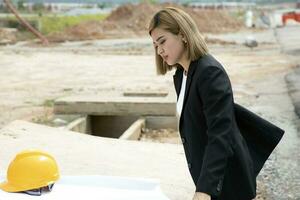 South east Asian construction worker engineer management at construction site hard safety hat helmet photo