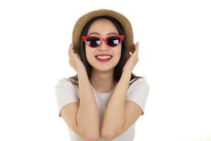 Beautiful young south east Asian woman wearing red frame sunglass eyewear hat pose fashion style white background look around copy text space photo