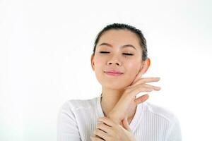 beautiful young south east Asian Chinese woman hand on cheek chin eye closed on white background photo