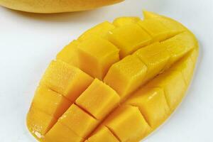 ripe yellow mango cut slice whole on white background photo