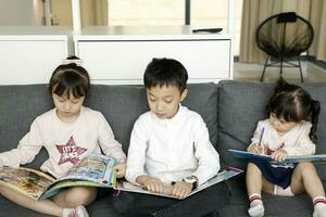Child Family father mother daughter son sit on sofa reading writing study teaching photo