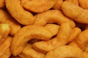 Deep fried battered onion pakoda slightly curly crispy spicy ready to eat snack photo